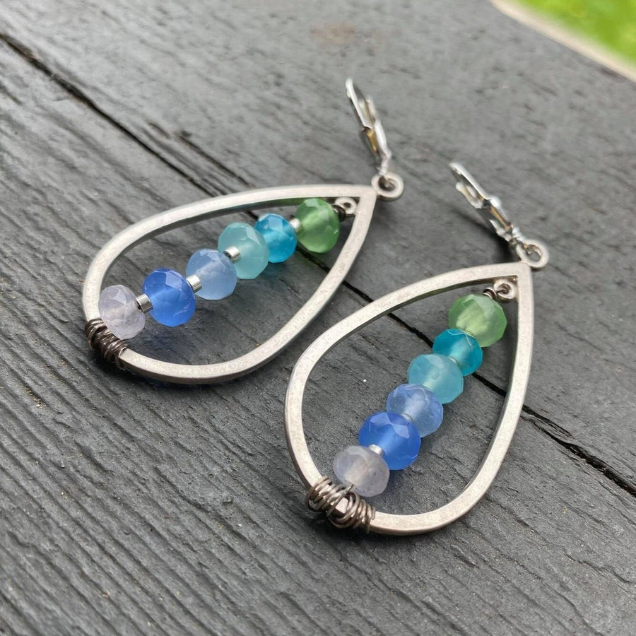 Artisan Sterling Silver teardrops with a single line of cascading blue colored quartz stones. Very unique, one of a kind. Leverback earwires